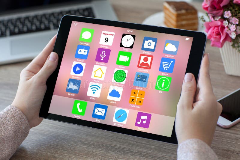 Woman Hands Holding Tablet Computer with Home Screen Icons Apps Stock