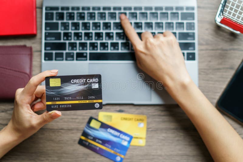 Woman hands holding and using cradit card for shopping online royalty free stock photos