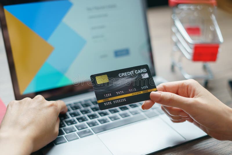 Woman hands holding and using cradit card for shopping online stock photos