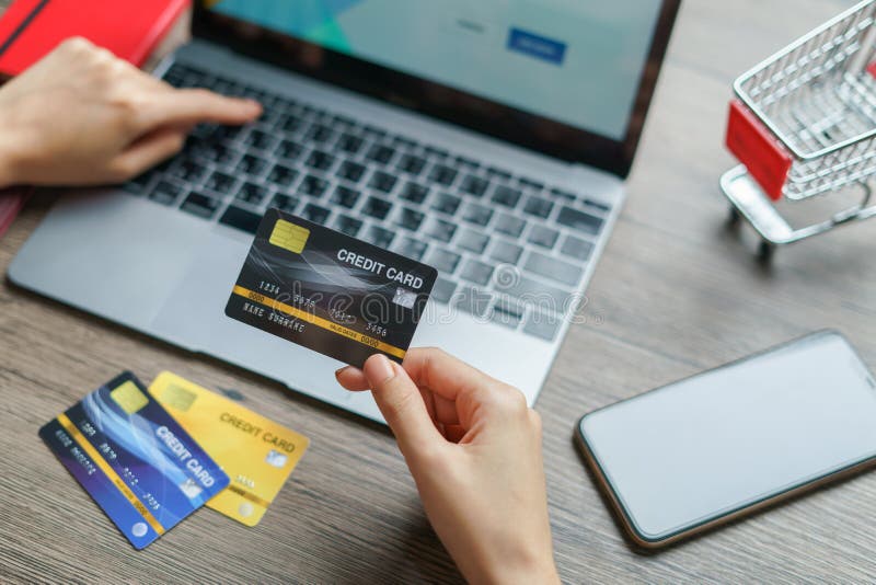 Woman hands holding and using cradit card for shopping online royalty free stock photo