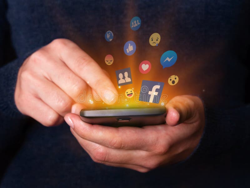 Woman hands holding and using smartphone mobile cell phone check Facebook social media network app. royalty free stock photography