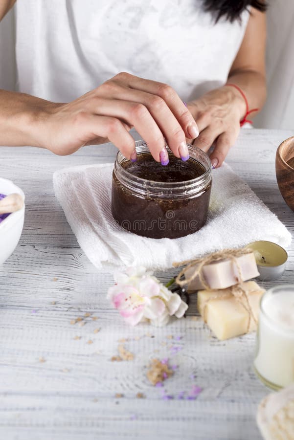 Woman hands receiving a hand scrub peeling. Peel, applying.