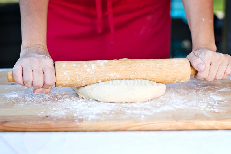 Woman hands rolling dough stock photography