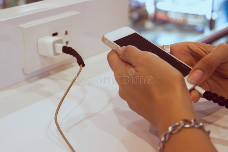 Woman hands using mobile phone while charging, Danger, Technology concept