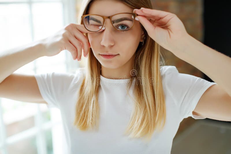 A Cute Girl With Bad Eyesight The Woman Has Poor Eyesight. Stock Image - Image of poor, adult: 177730973