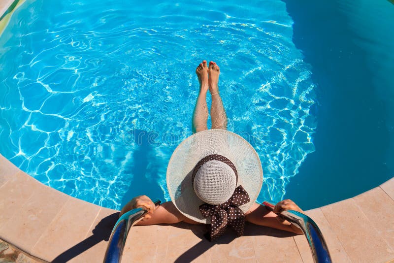 Woman in hat relaxing at the pool royalty free stock images