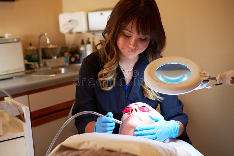 Woman Having Dermo Abrasion Cosmetic Treatment At Spa