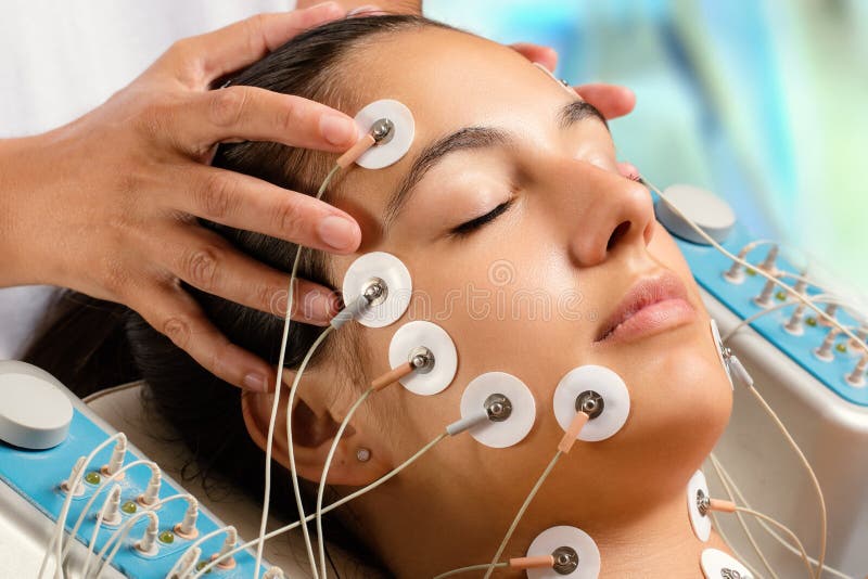 Woman having electrical facial skin tightening treatment. stock images Woman having electrical facial skin tightening treatment. stock images