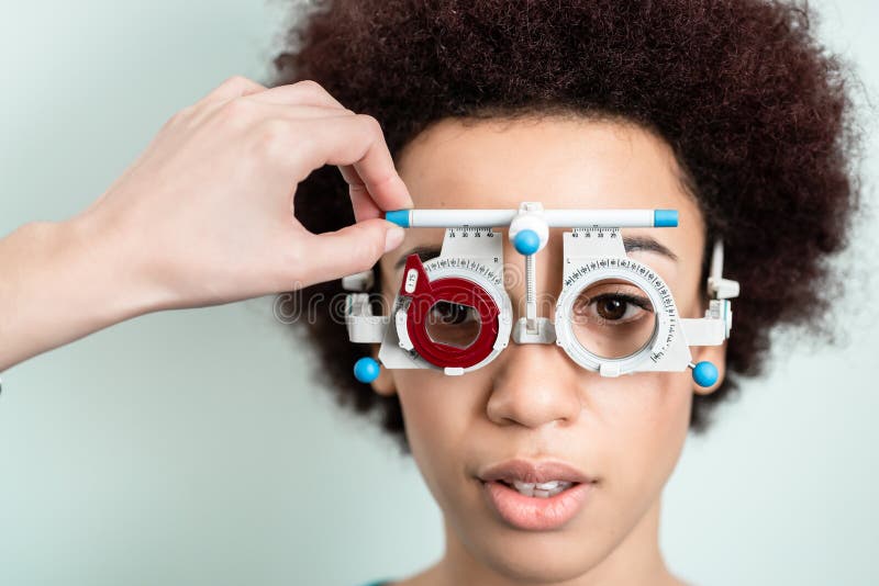 Woman having eyesight test with phoropter for new glasses