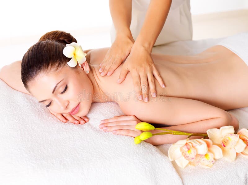 Woman having massage of body in spa salon