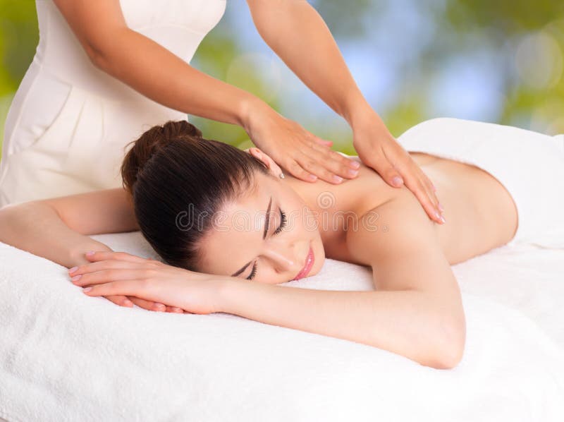 Woman having massage of body in spa salon