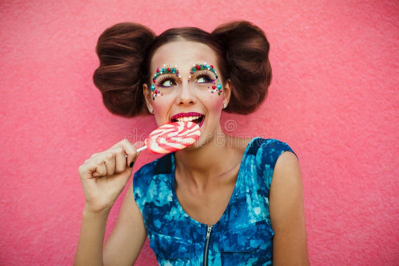 Woman having toothache after eating sweets, lollipop and teeth problem. girl eating sweet candy. caries. Colorful Lollipop in perf stock photo Woman having toothache after eating sweets, lollipop and teeth problem. girl eating sweet candy. caries. Colorful Lollipop in perf stock photo