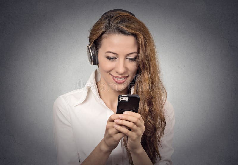 Woman With Headphones Reading Sms On Smartphone Listening Radio Stock