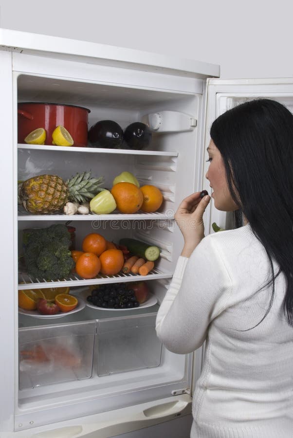 Woman with healthy food in fridge