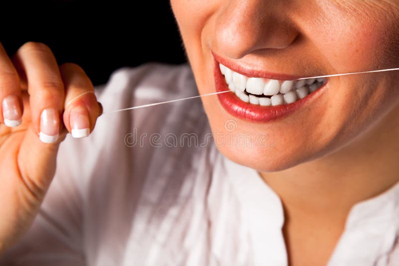 Woman healthy teeth closeup on black