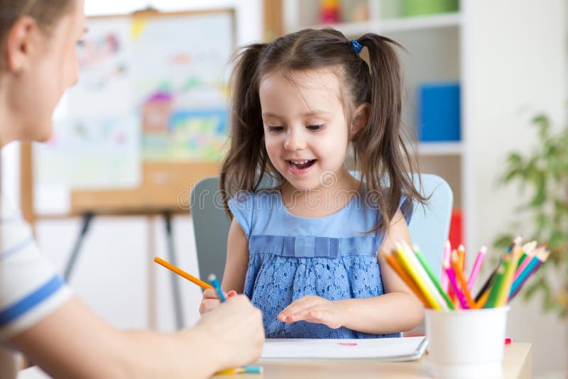 Woman helping her child daughter with homework