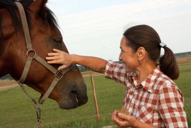 Woman with her horse stock image