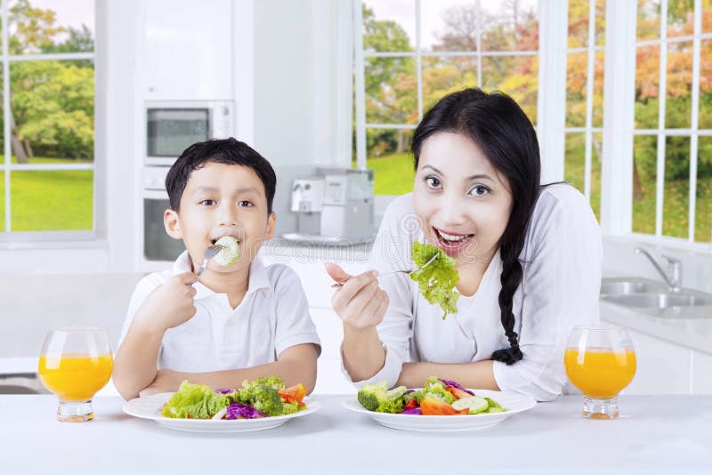 Woman and Her Son Enjoy Salad Stock Ph picture pic