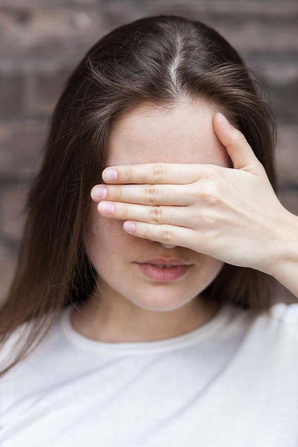 Woman hides her face palm stock image. Image of pensive - 26164485
