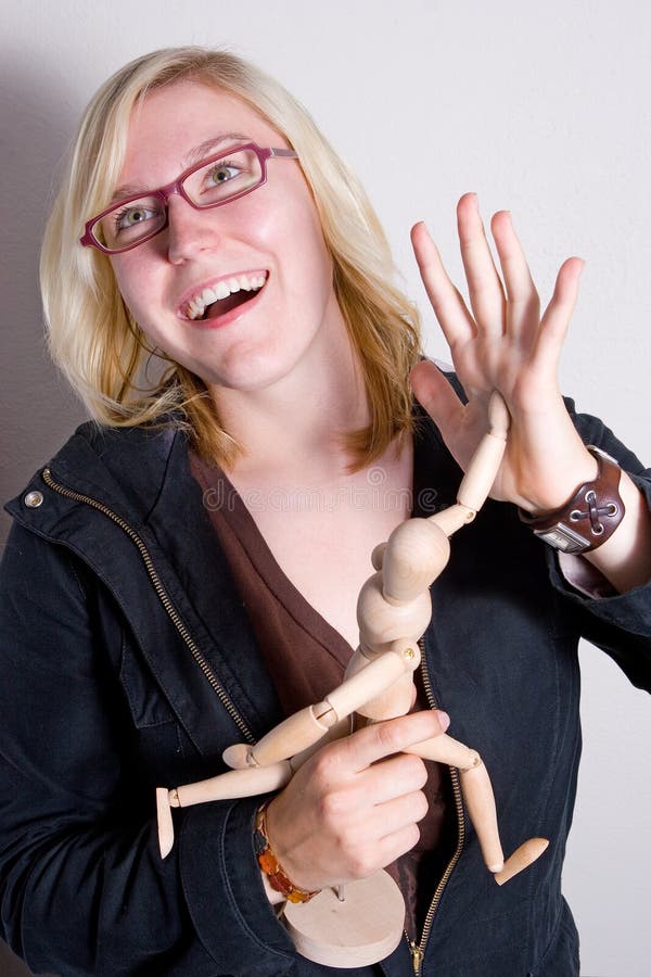 Woman high-five with wooden doll.