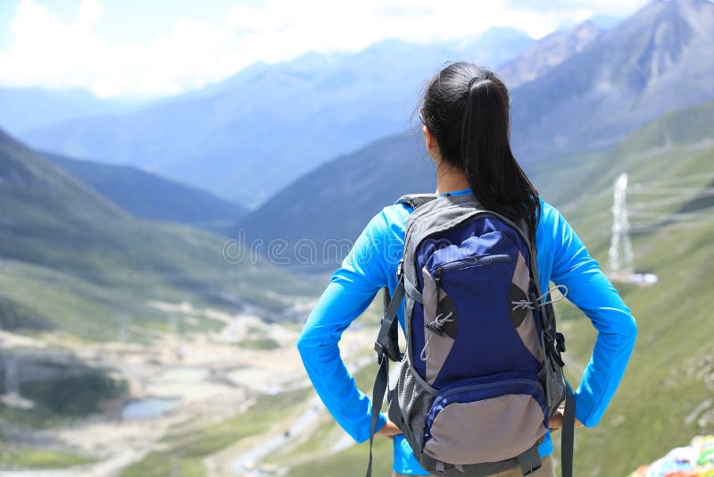 Woman hiker enjoy the view at plateau mountain peak in tibet royalty free stock photography Woman hiker enjoy the view at plateau mountain peak in tibet royalty free stock photography