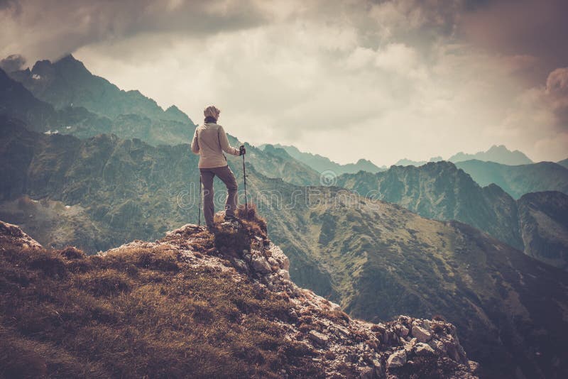 Woman hiker on a top of a mountain. Woman hiker on a top of a mountain