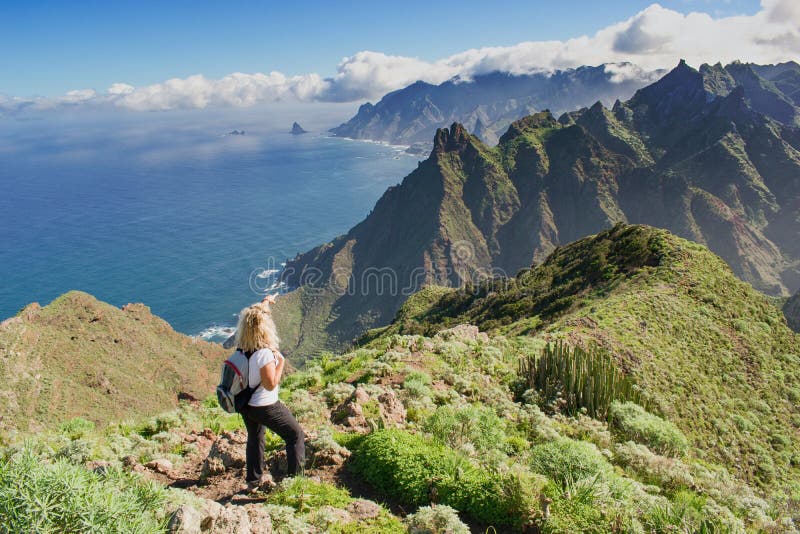 Woman hiker watching beautiful costal scenery. - Tenerife, Canary Islands, Spain. Western coast view, mountain Anaga