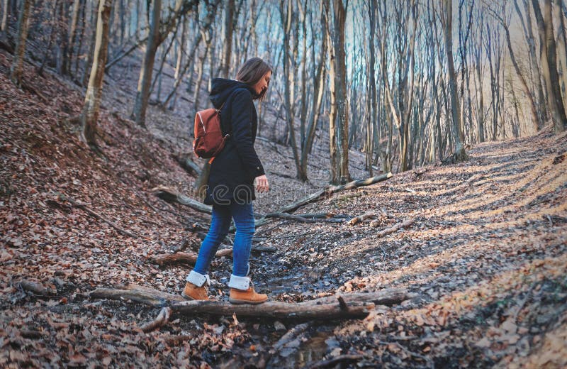 Woman hiking crossing creek in woods royalty free stock photo Woman hiking crossing creek in woods royalty free stock photo
