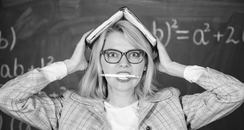 Woman hold book bite pen chalkboard background. Learn be inspiring teacher. Inspiring teacher spark motivation. Looking.