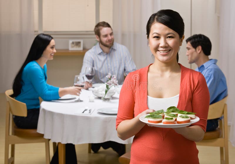 Woman holding appetizer and serving friends royalty free stock images Woman holding appetizer and serving friends royalty free stock images