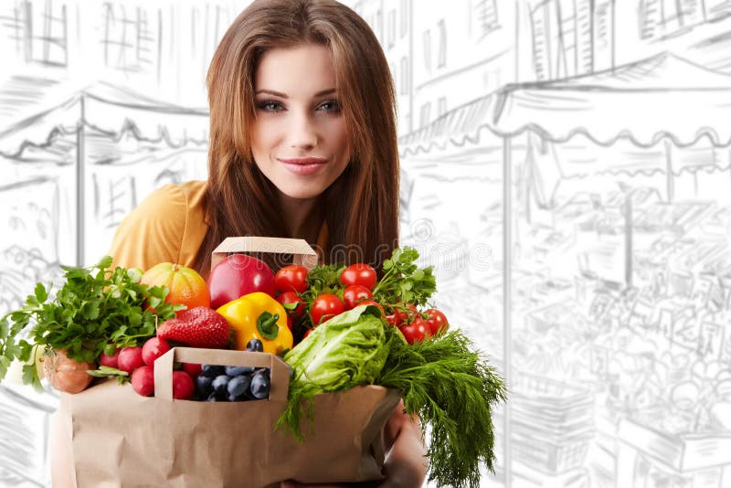 Woman holding a bag full of healthy food