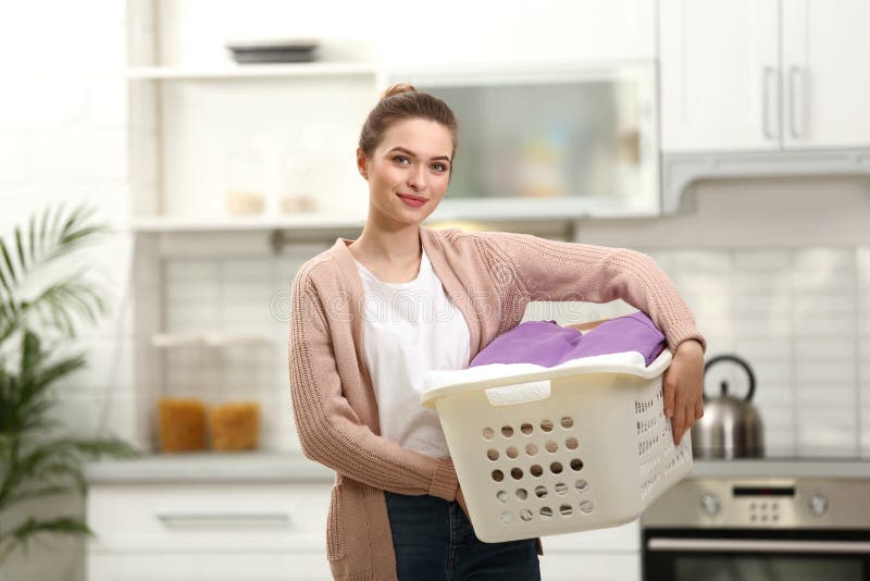 Woman holding basket with clean laundry