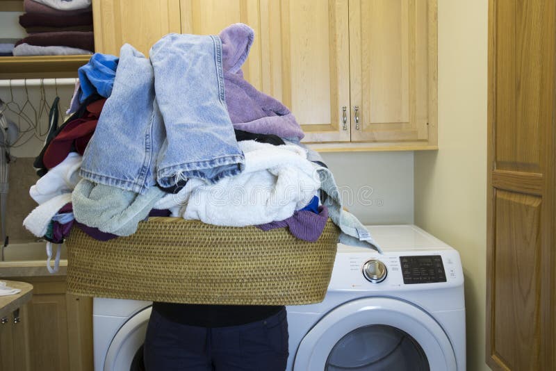 Woman holding basket of dirty laundry in home room royalty free stock photos Woman holding basket of dirty laundry in home room royalty free stock photos
