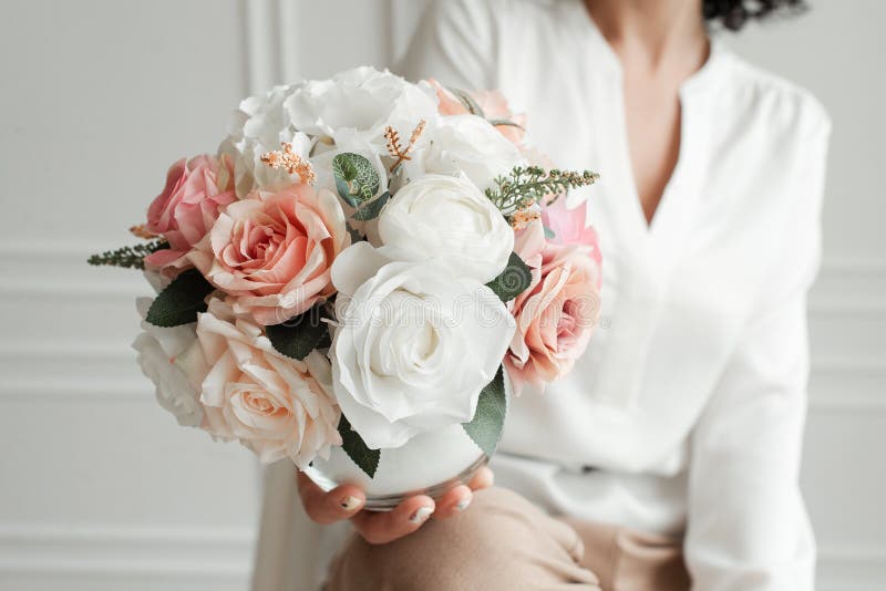 woman holding a bouquet of decorative flowers