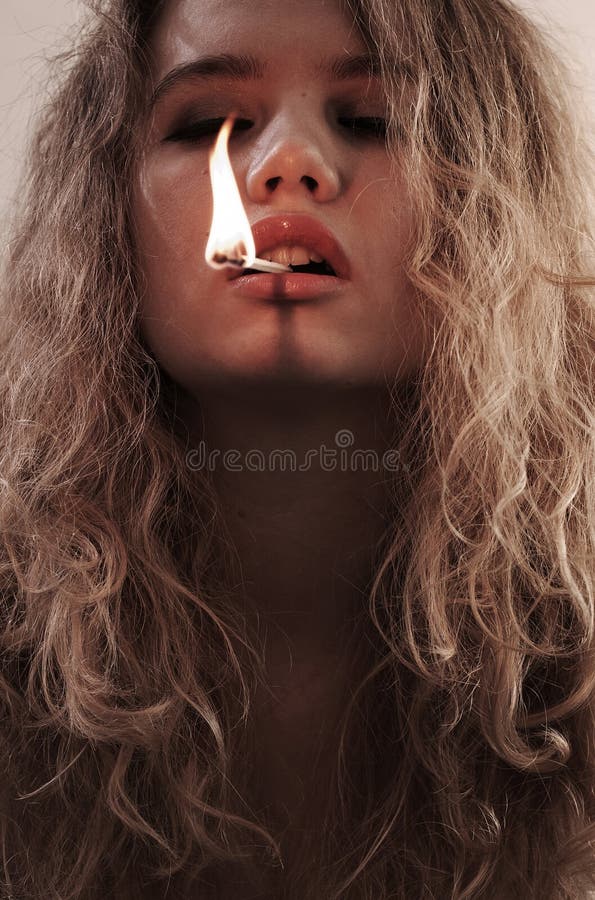 Woman holding burning match