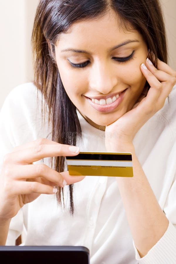 Woman holding credit card stock photo. Image of home 10311498