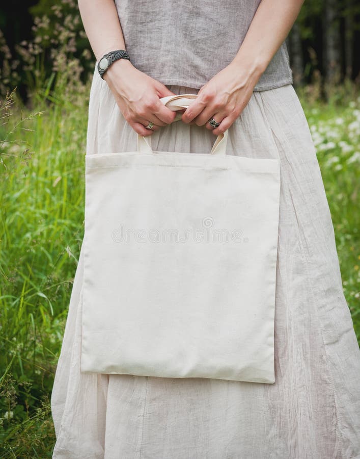 Woman holding empty linen bag. Template mock up stock photos Woman holding empty linen bag. Template mock up stock photos