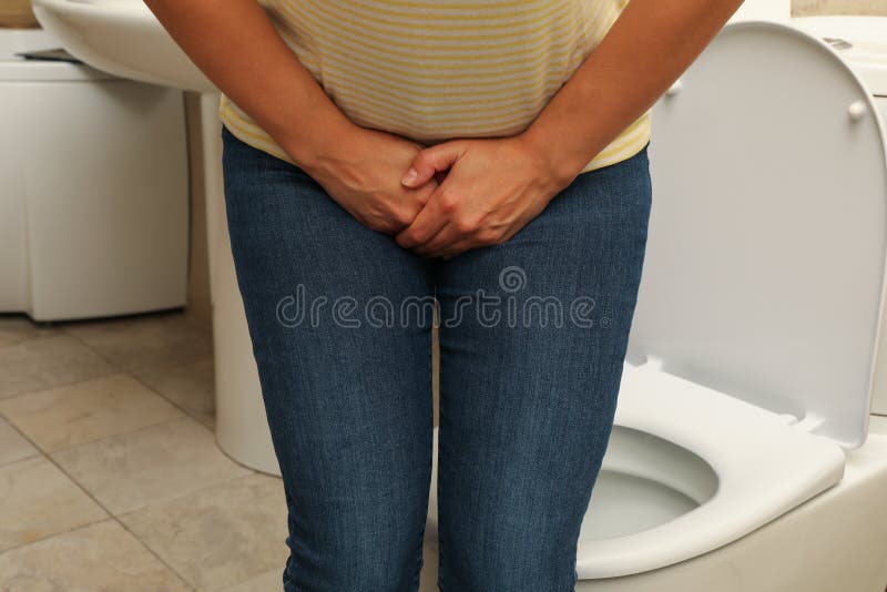 Toilet pissing woman stretching her butt cheeks over bowl