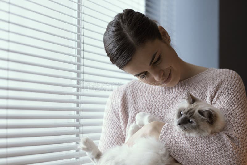Woman holding her beautiful cat stock images