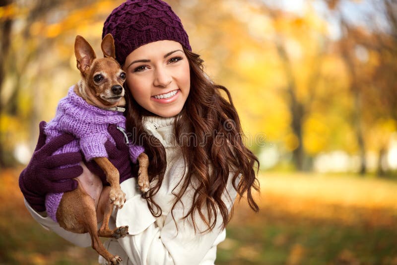 Woman holding her puppy after in the park