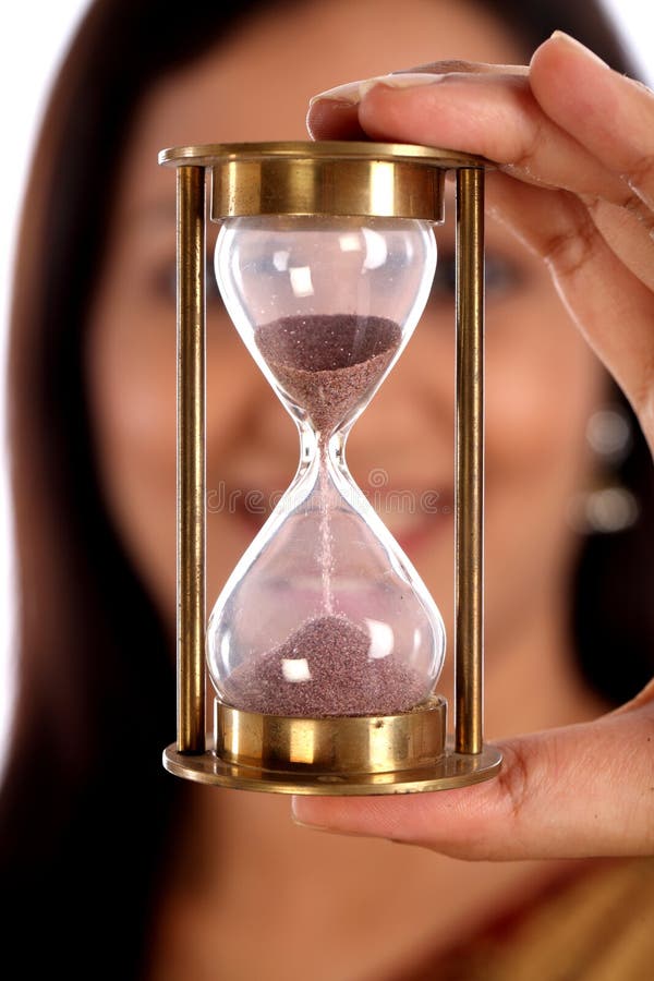 Woman holding hour glass. 