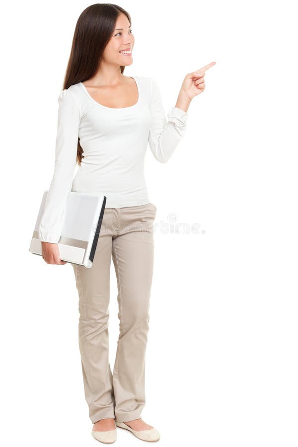 Woman Holding Laptop While Pointing At Copyspace stock photo Woman Holding Laptop While Pointing At Copyspace stock photo