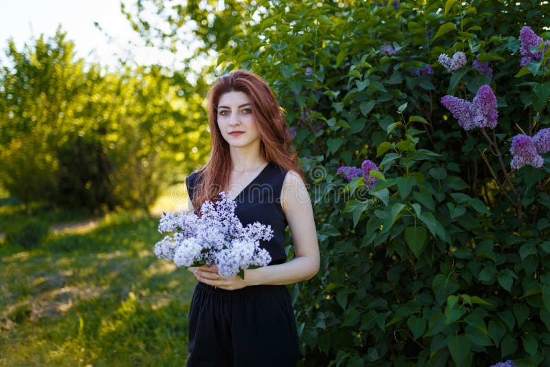 Portrait of Woman Holding Lilac Flowers Bouquet on Blossomig Bush Stock ...