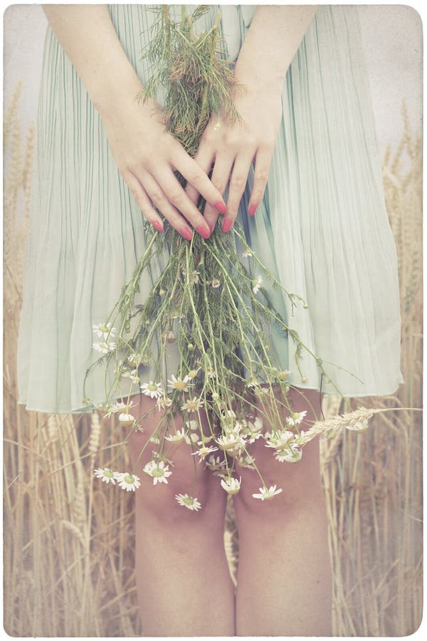 Woman holding marguerite flowers