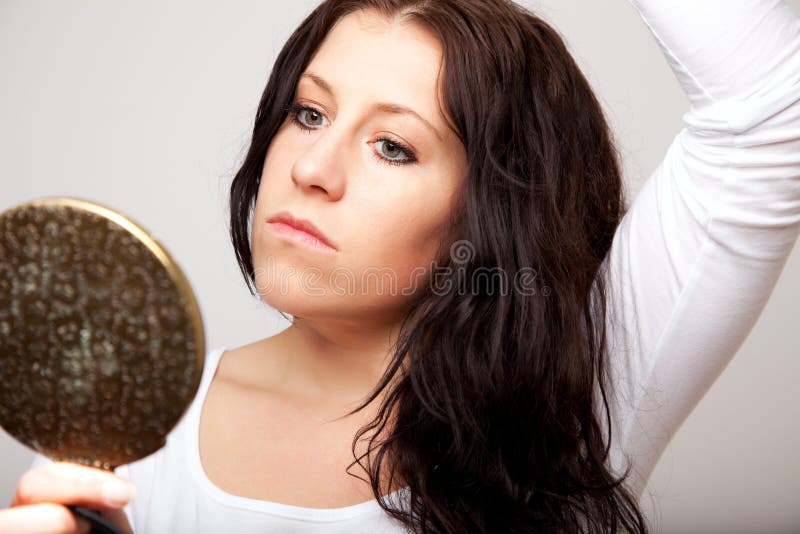 A Woman Holding a Mirror stock photo. Image of hand, grooming 24347848