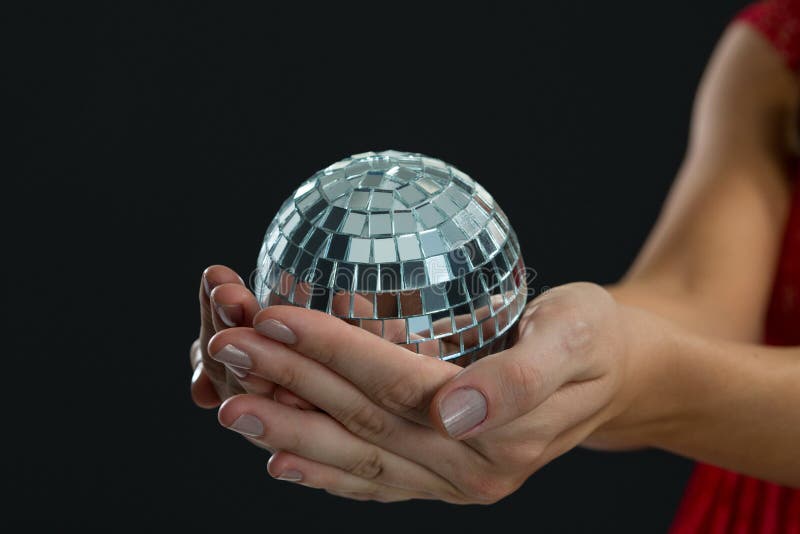 Woman holding mirror ball