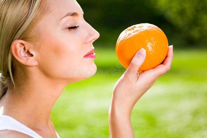 Woman holding an orange royalty free stock image Woman holding an orange royalty free stock image