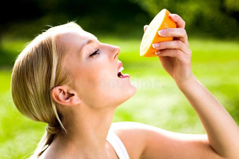 Woman holding an orange royalty free stock photos Woman holding an orange royalty free stock photos