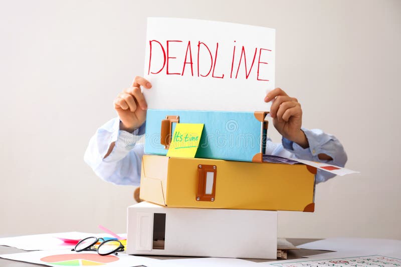 Woman holding paper with word DEADLINE and pile of documents on table stock images Woman holding paper with word DEADLINE and pile of documents on table stock images