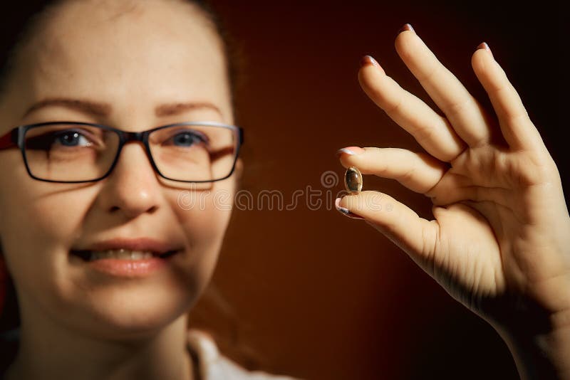 Woman Holding A Pill In Her Hand Treatment Of Colds Stock Image